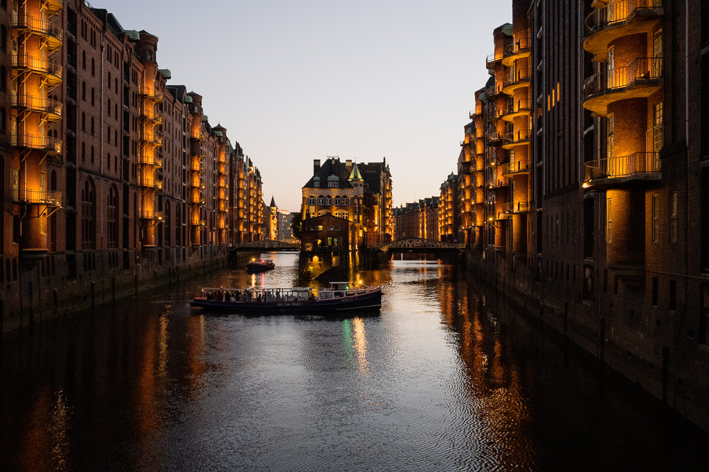 Wasserschloss in der Speicherstadt Hamburg mit Booten bei Nacht
